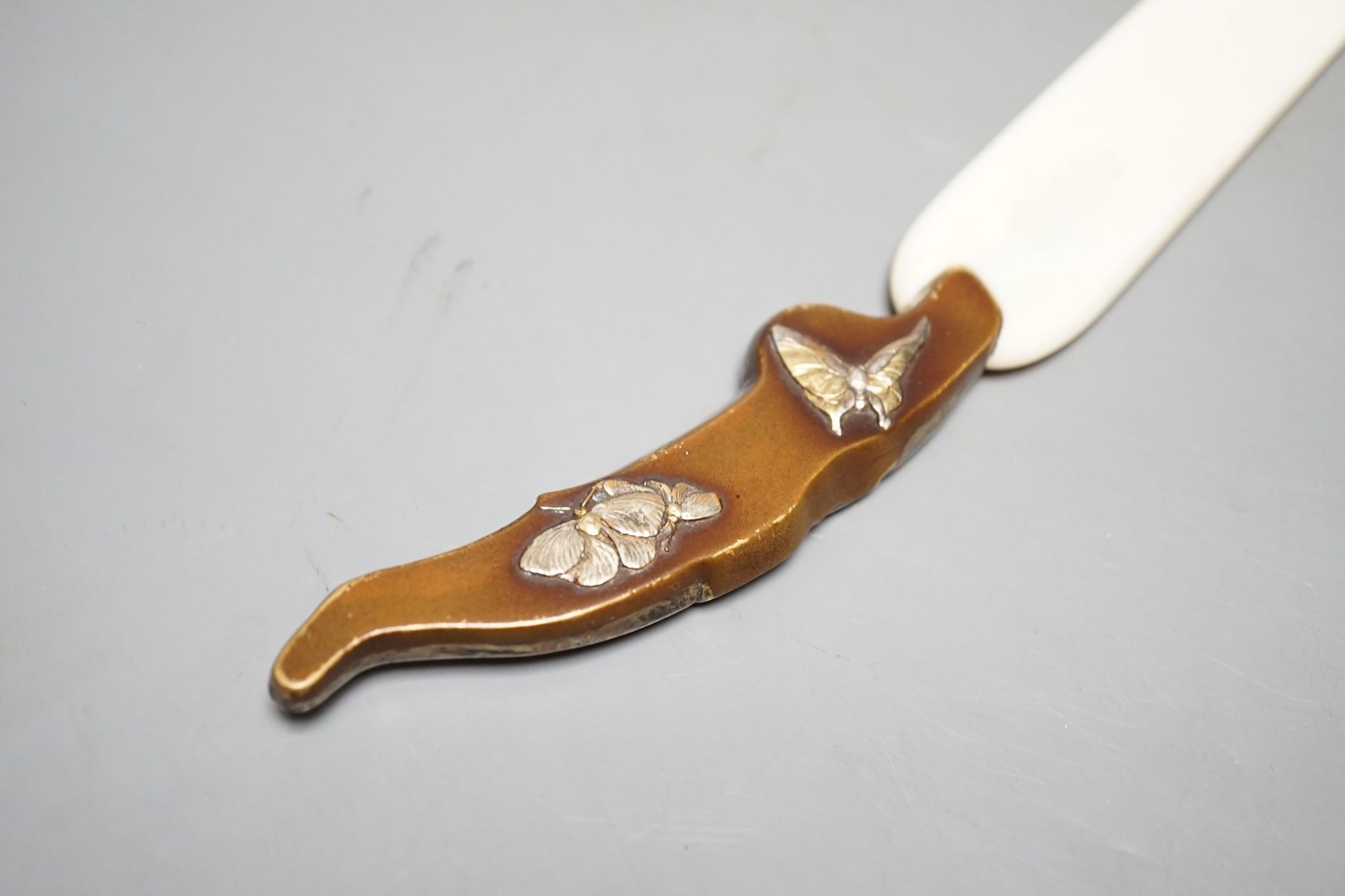 A Japanese mixed metal and ivory page turner, 38 cms long.